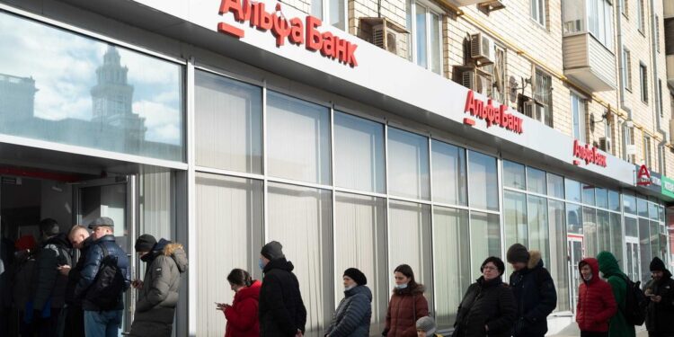 Russians are scrambling to withdraw US dollars at ATMs as the ruble hits a record low on the invasion of Ukraine