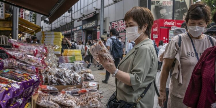 Japan’s households spend less as higher inflation bites